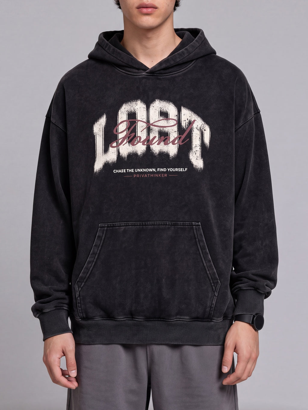 Front view of a black Lost & Found washed hoodie with a chest graphic and kangaroo pocket.