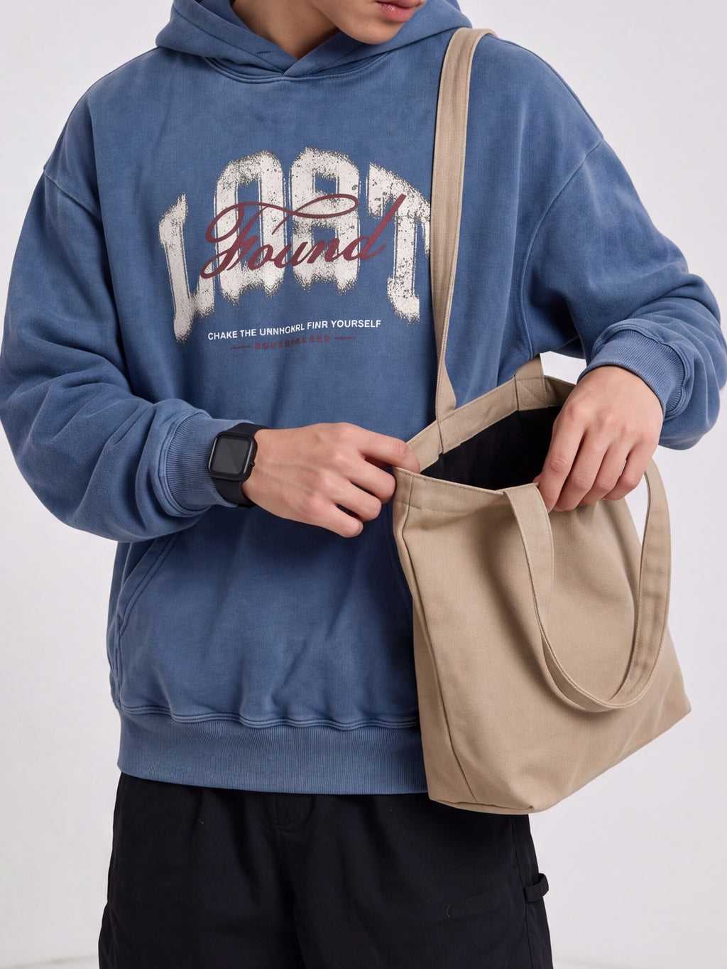 Blue Lost & Found washed hoodie styled with a beige tote bag.