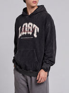 Side-angle view of a black Lost & Found washed hoodie, showing the roomy sleeves and ribbed cuff.